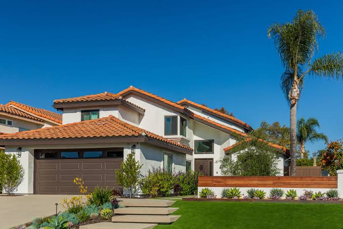 A San Diego home with a tile roof, palm and drought-tolerant front planting