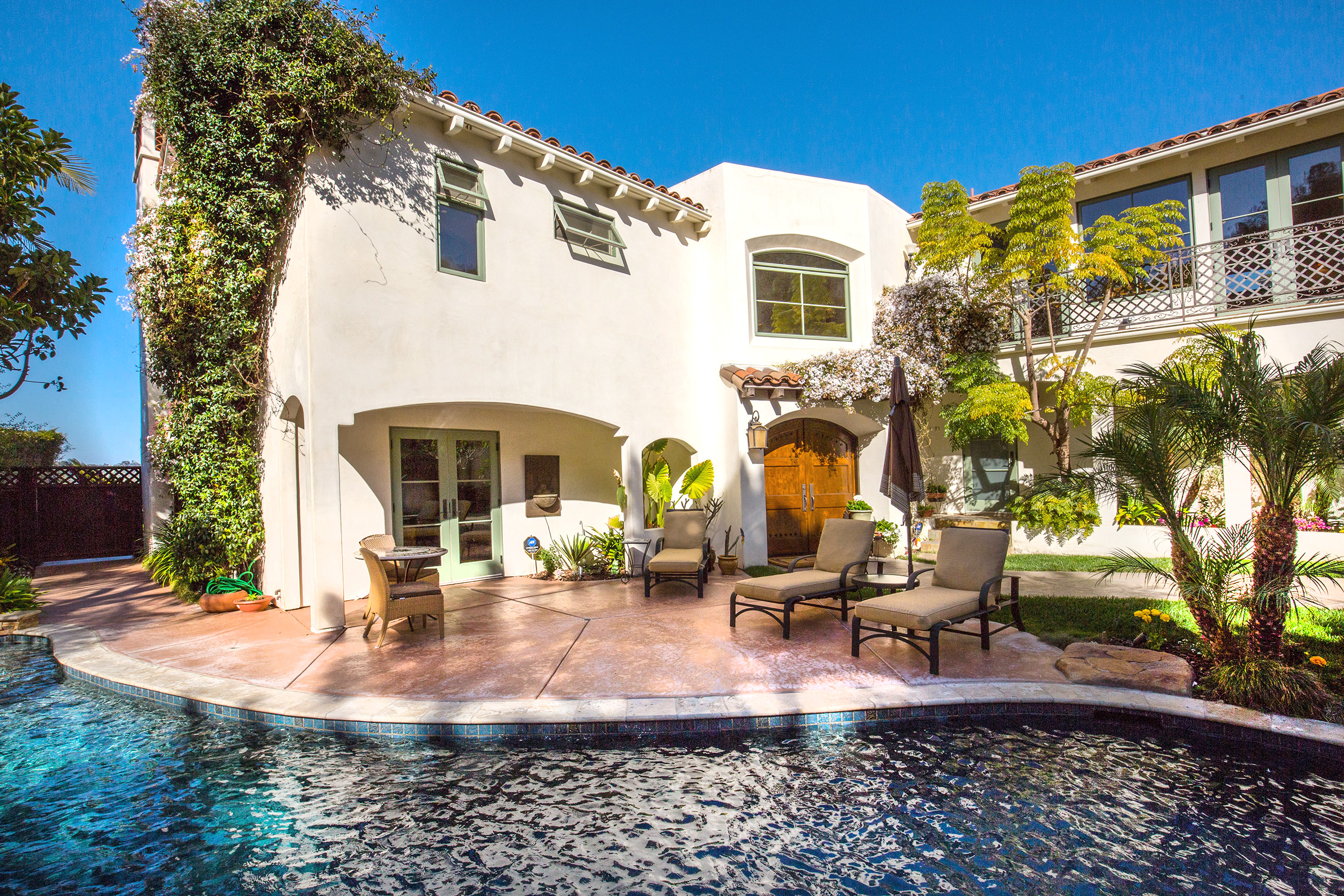 A pool, patio and mature landscaping at a San Diego home